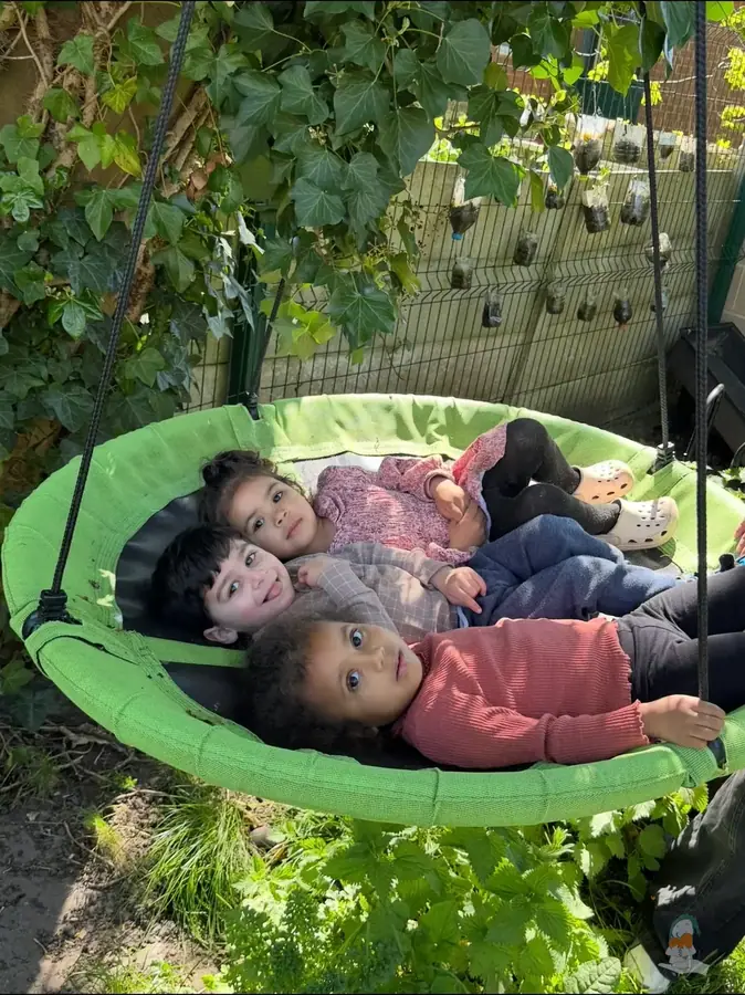 Children relaxing together in the garden hammock